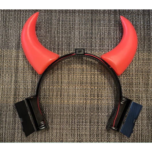 Devil Horns that light up. Each horn blinks. Battery operated.