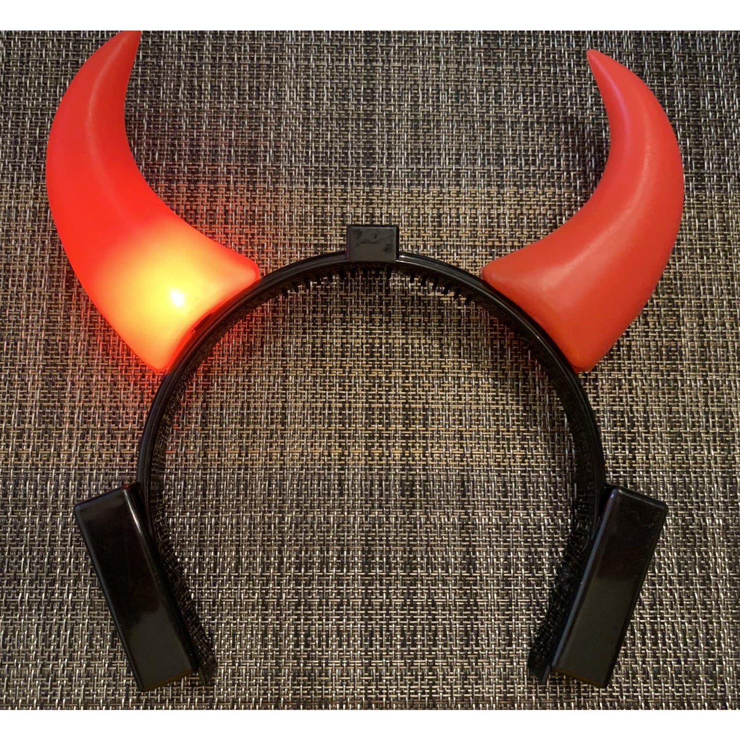 Devil Horns that light up. Each horn blinks. Battery operated.